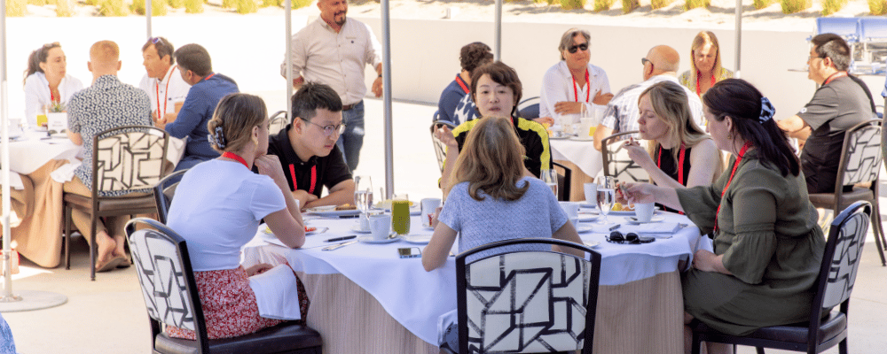 group of attendees networking during an incentive travel event over breakfast