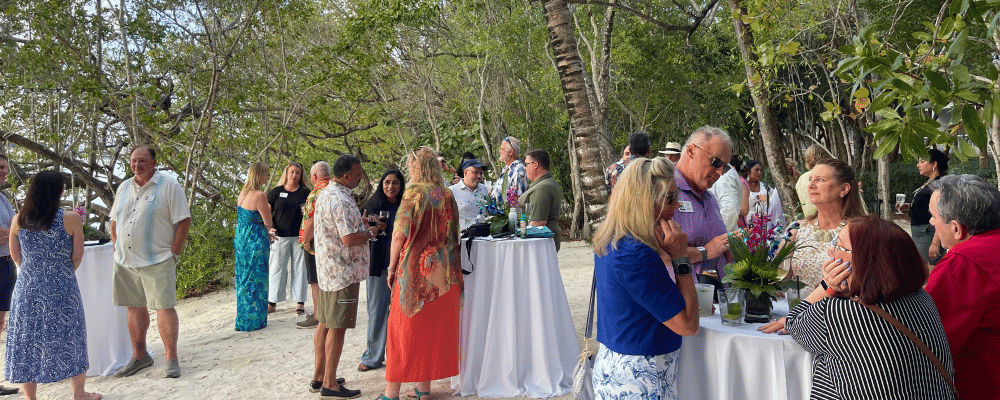 group of incentive trip attendees networking on the beach