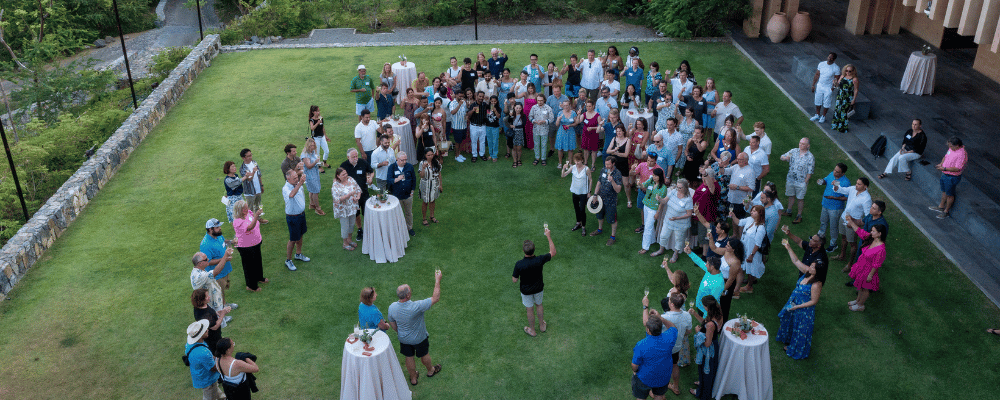 group of event attendees networking at the Four Seasons Resort Tamarindo