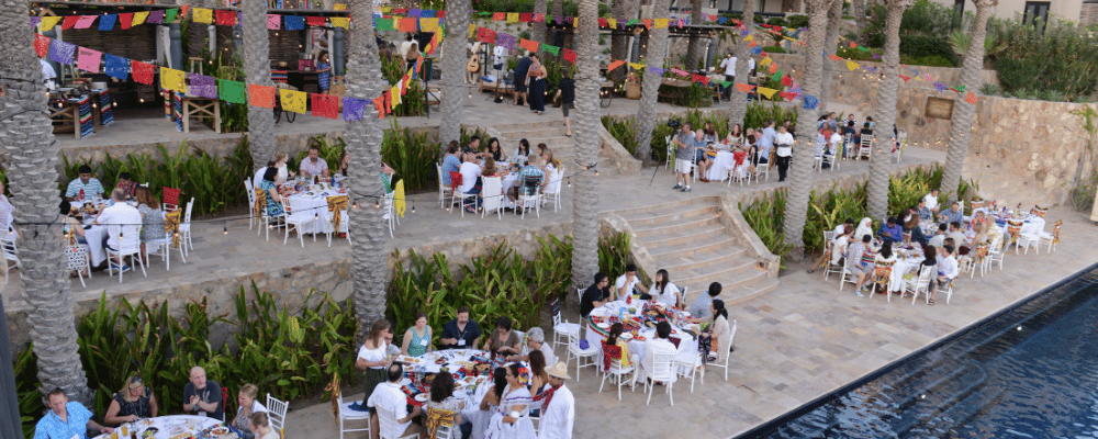 group of people enjoying incentive travel dinner by the pool