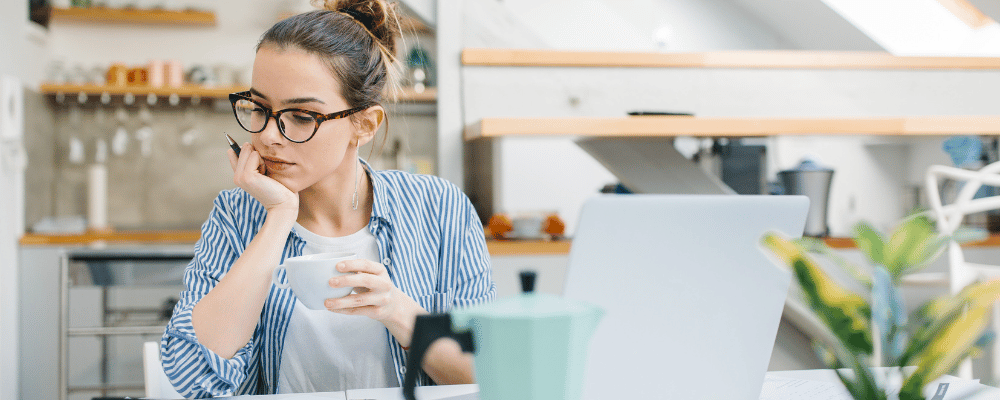 woman evaluating incentive trip cost on laptop