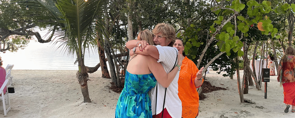 two attendees hugging during an incentive trip