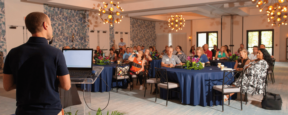 presenter speaking to a group of franchise attendees 