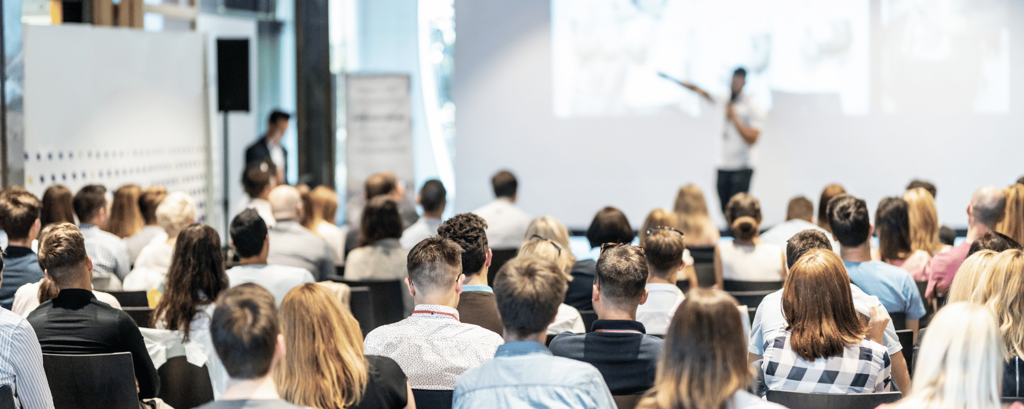 A keynote speaker delivering a speech to a large audience