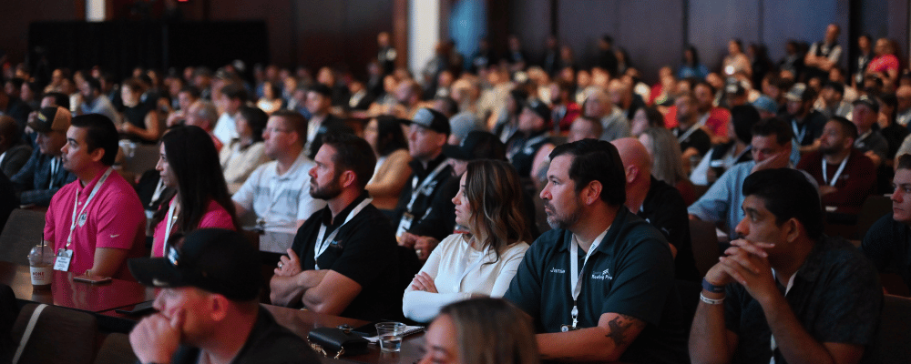 group of attendees watching a presentation with title ' let's plan your best event yet'