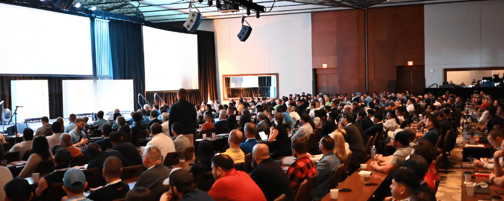 group of attendees watching a presentation with title ' let's plan your best event yet'