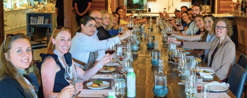 group of event attendees toasting during wine tasting