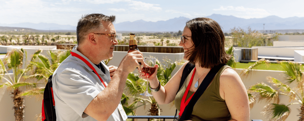 two attendees networking with drinks at a corporate event