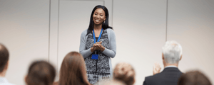 woman presenting to group at national sales meeting