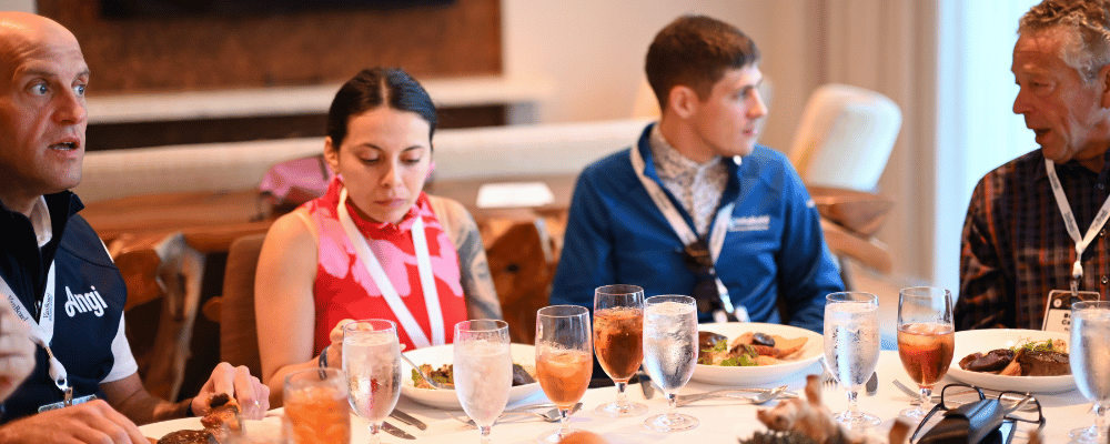 group of event attendees eating dinner at a corporate conference