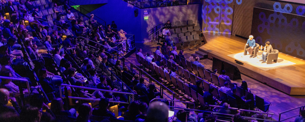 group of attendees watching a conference presentation