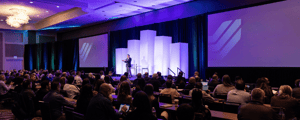 group of attendees watching a conference presentation