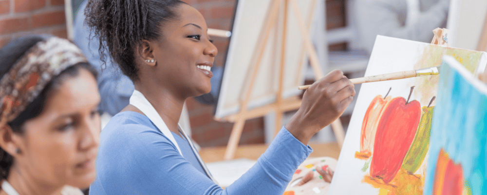 group attending a painting class during an incentive trip