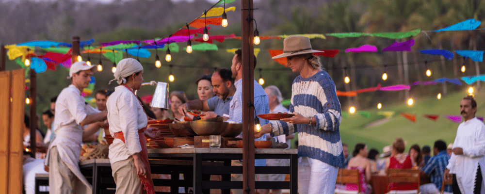 group of event attendee getting dinner from a buffet in Mexico 