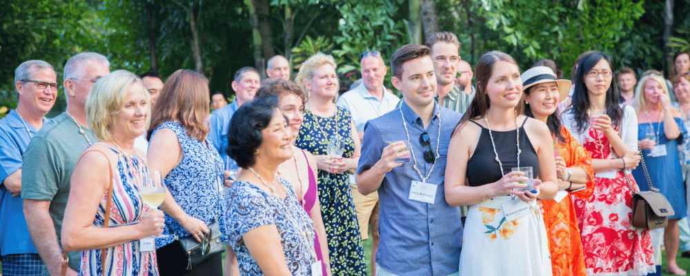 group of event attendees listening to a speech during an incentive trip