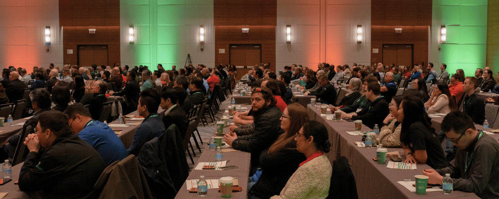 group of event attendees watching a conference presentation