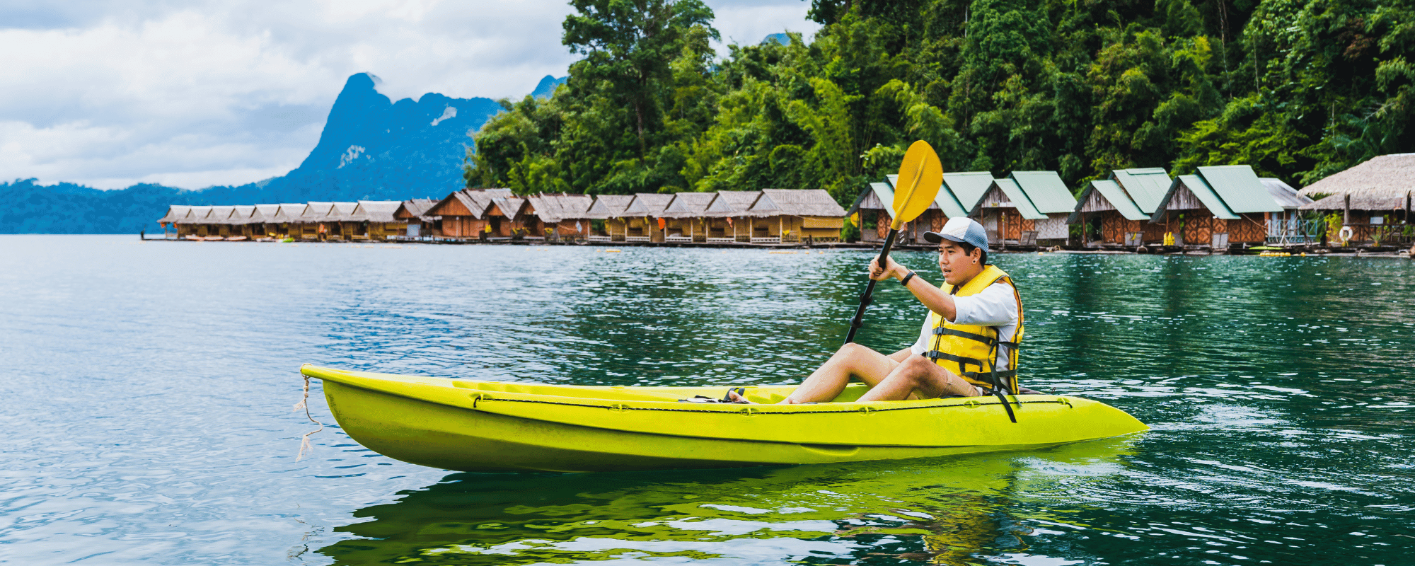 man kayaking in the bay at an all-inclusive corporate retreat