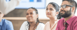 Group of people listening to a speaker at a sales kickoff
