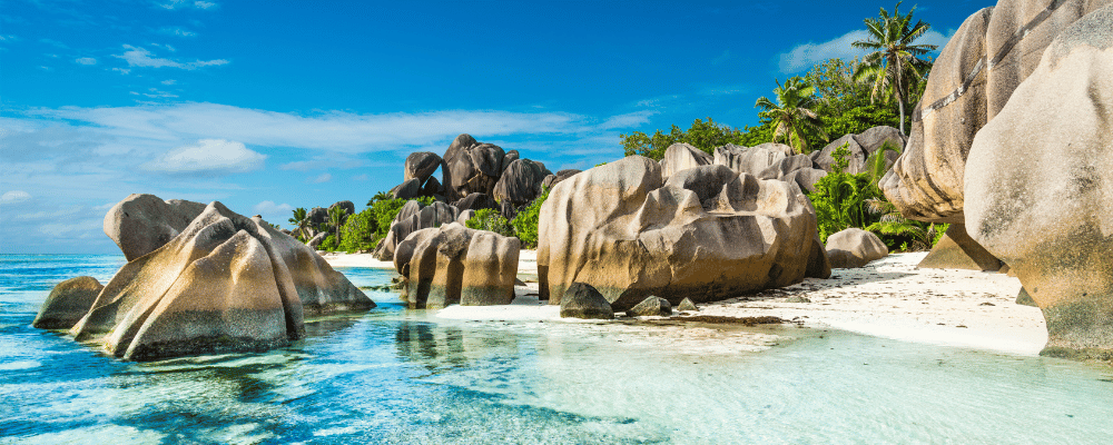 seychelles executive retreat featuring bright beaches, large rocks and blue water