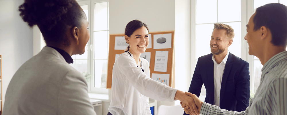 Group of corporate employees shaking hands and agreeing on a sponsorship package