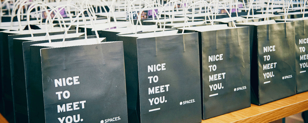 swag bags lined up at a conference with text 'nice to meet you'