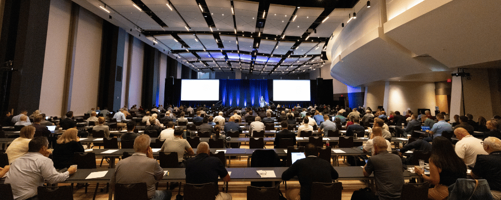 group of event attendees watching a corporate conference presentation