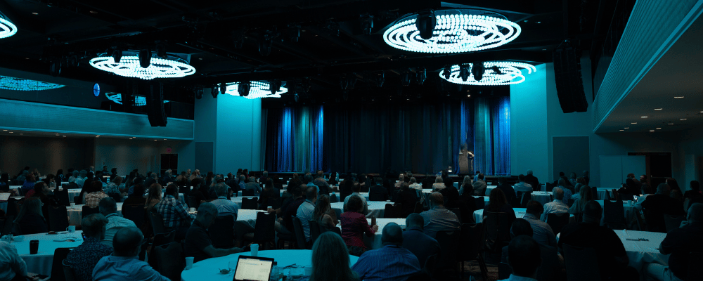 group of event attendees watching a corporate conference presentation