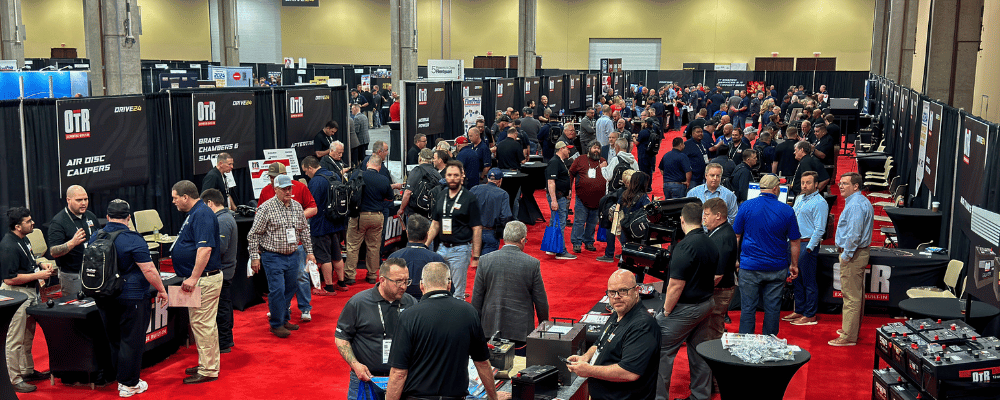 group of event attendees walking around an expo floor