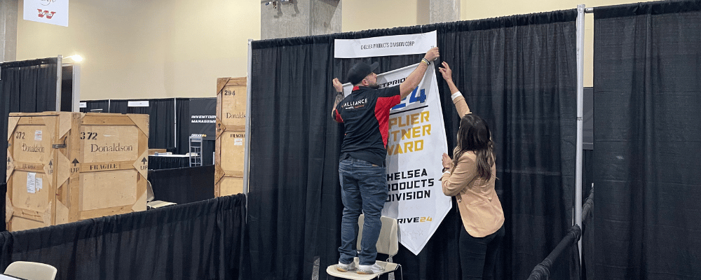 event manager helping put up signs