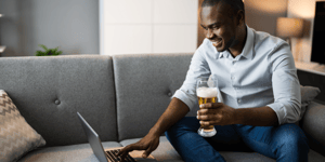 man holding a beer while on a virtual networking event
