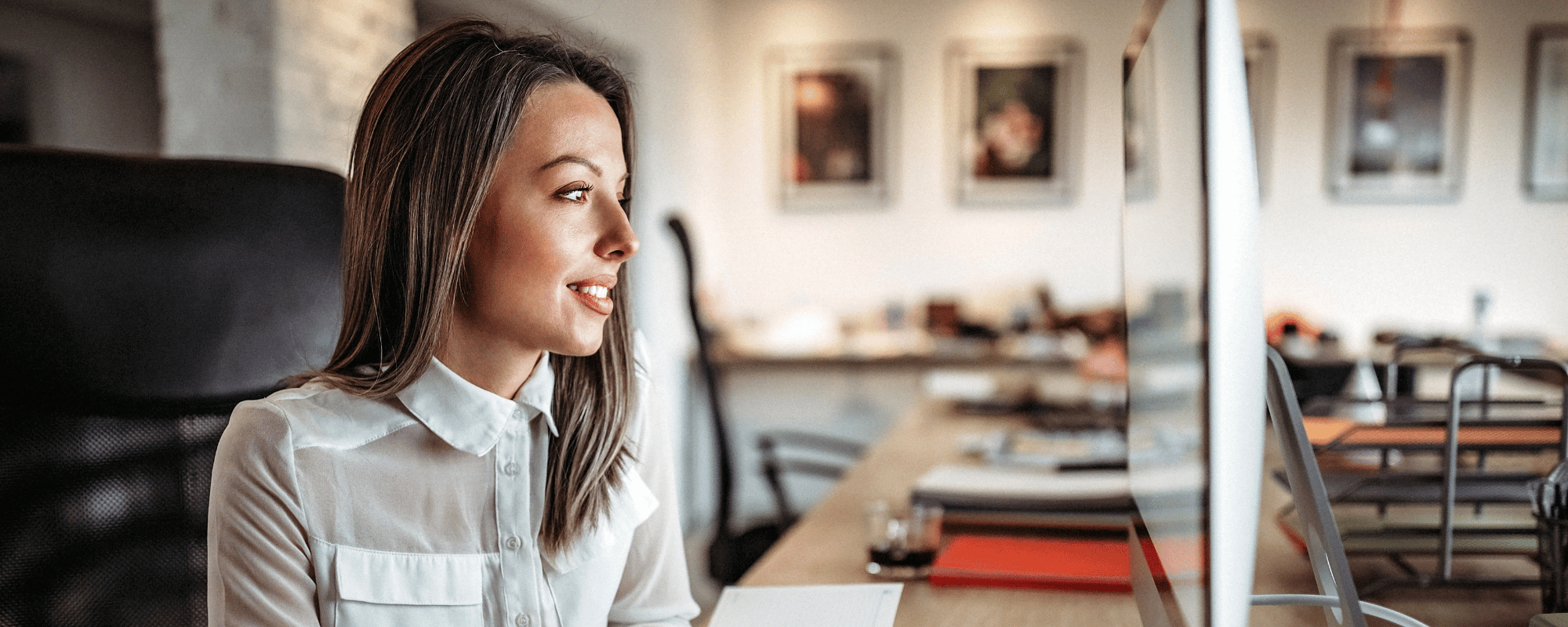 woman sits at computer participating in a virtual sales kickoff