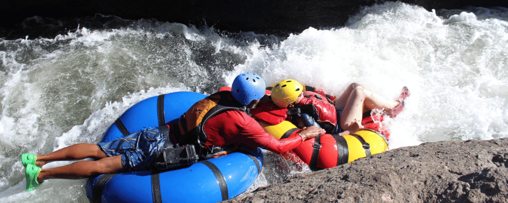 two men white water rafting in costa rica