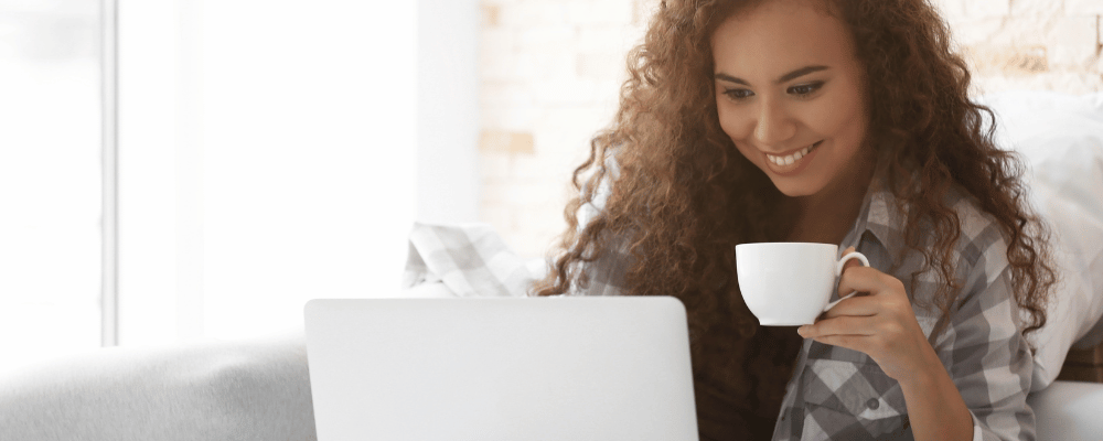 woman attending a virtual or hybrid event on her computer.